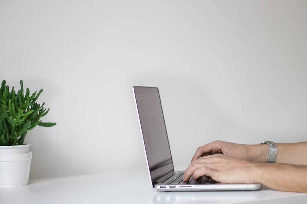 A student working on a laptop at a desk